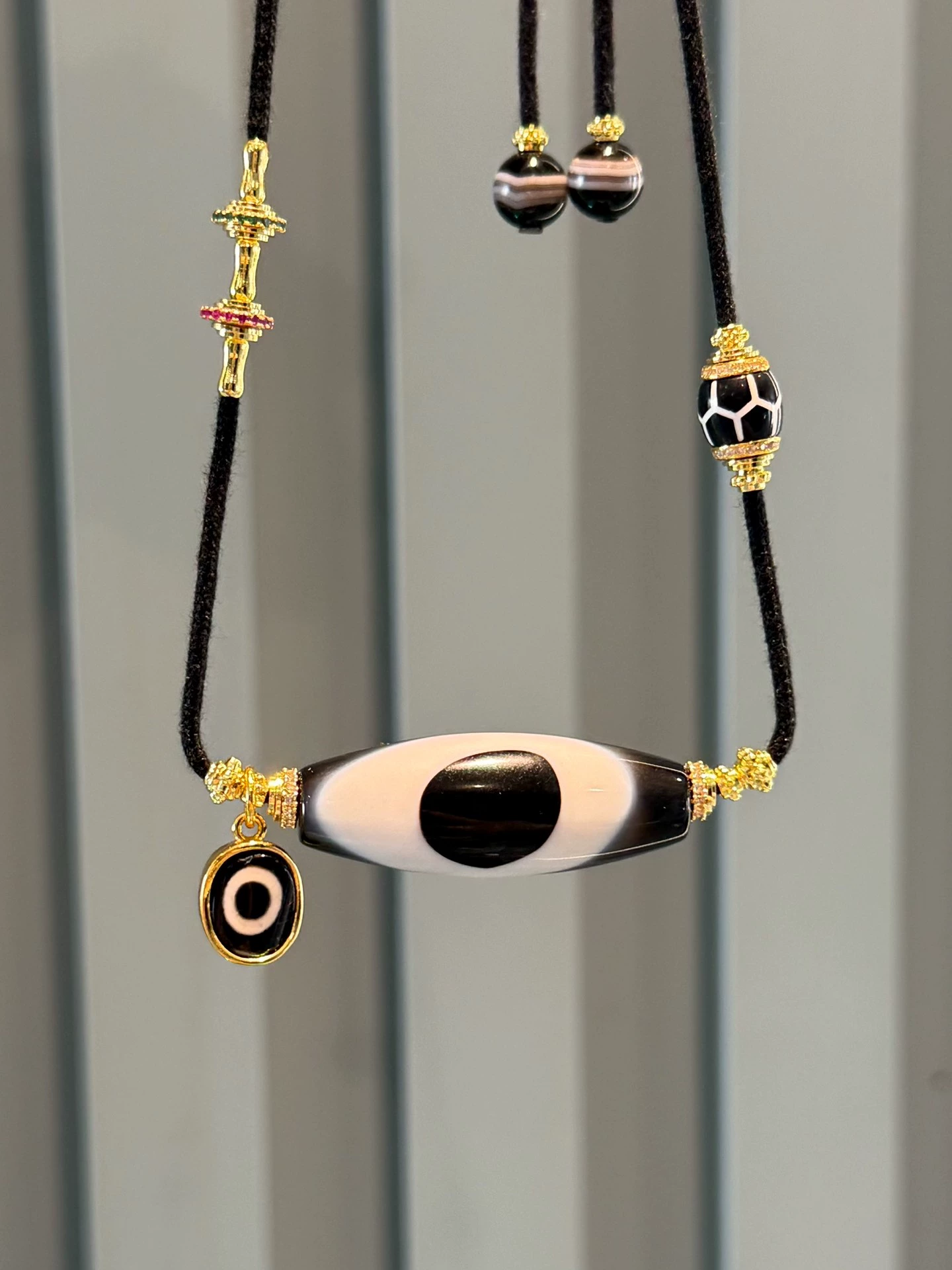 Black and Gold Coconut Palm Kernel 8mm (approx. 0.31 inches) Modified Single - loop Multi - gemstone Bracelet (Incorporating Ultra - rare Blue - infiltrated Lava Agate, Layered Agate, and Silk - like Agate) and Black - and - White Dzi Bead Necklace